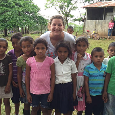 Kathryn Pautz is pictured standing with small boys and girls in Nicaragua. 