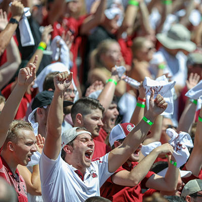 Students cheering at the football game.