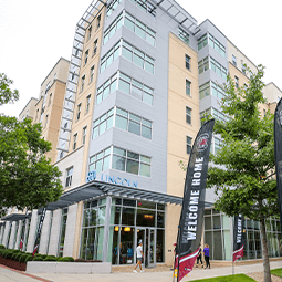 A sign for 650 Lincoln sits in the foreground, with small trees and green space in front of an apartment building with multiple stories.