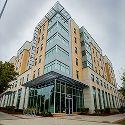 A sign for 650 Lincoln sits in the foreground, with small trees and green space in front of an apartment building with multiple stories.