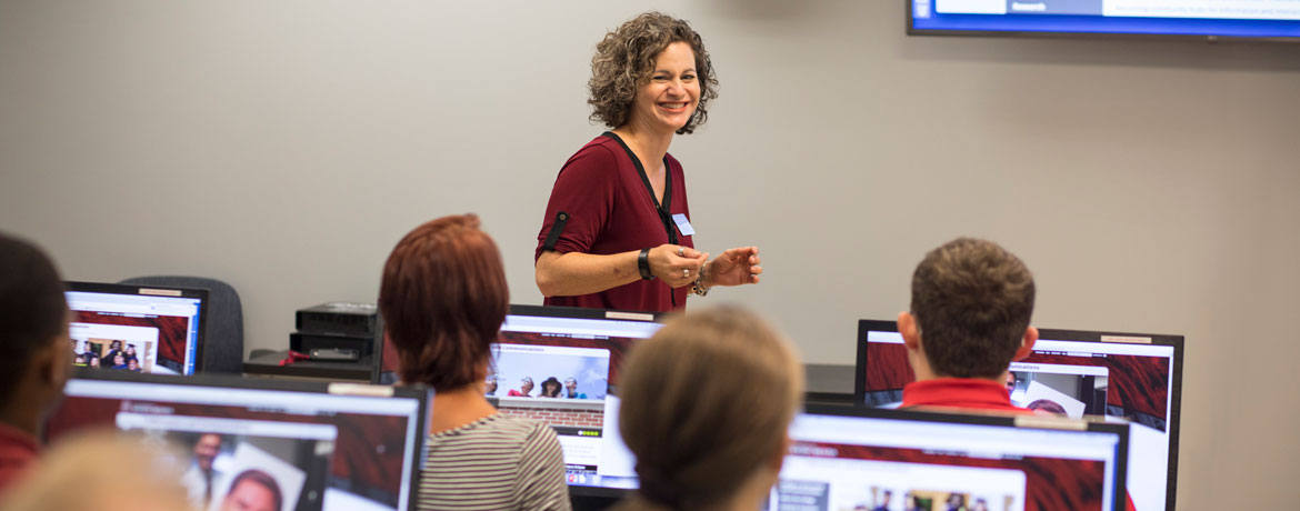 Professor smiles in front of class