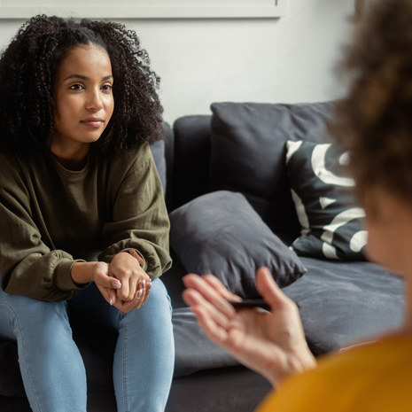 A student speaks with a counselor in her office.