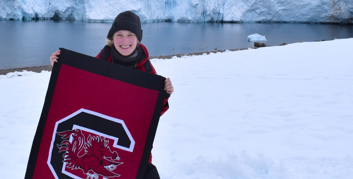 a USC student proudly shows a gamecock flag in the artic snow