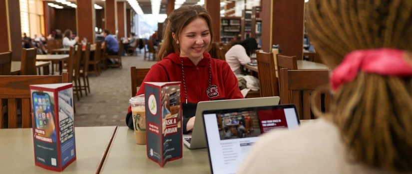 students using laptops in the library