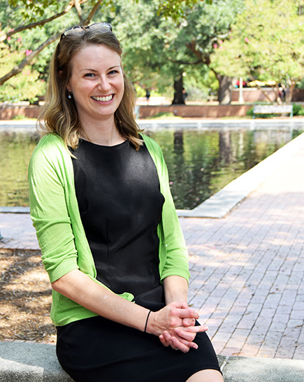 Digital Research Services librarian Amie Freeman sitting outside Thomas Cooper Library by the fountain