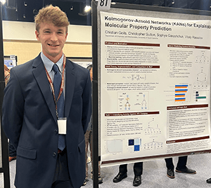 Christian Geils gives a presentation in a classroom, gesturing toward a projected slide as he explains his research to an audience.
