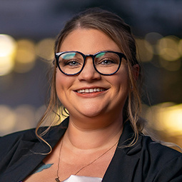 woman with dark hair can glasses on