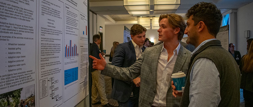 Students discussing their research results at the research sympsium.