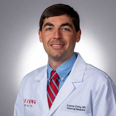 Portrait of Connor Evins in white lab coat.