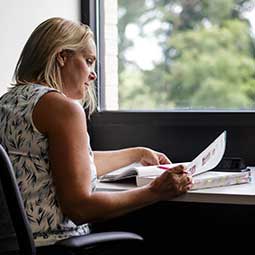 Student studying in a conference room.