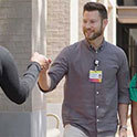 Male student fist bumps a friend.