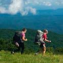 Two hikers on a mountain ridge.