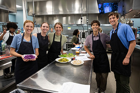 Students gathered around kitchen