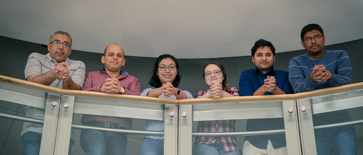 Lab members looking down from a balcony