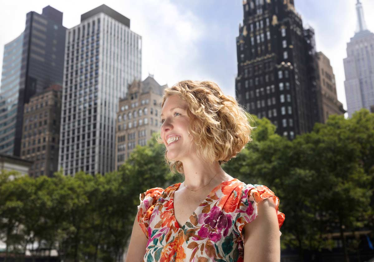 Sara Bako in Bryant Park with New York City skyline in background