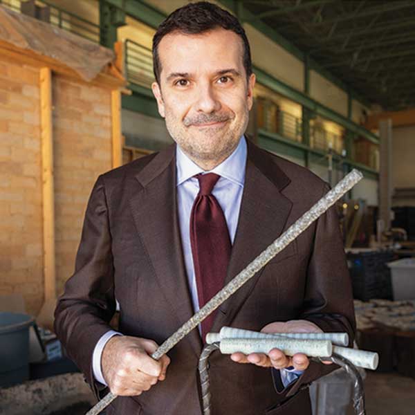 Fabio Matta smiles for the camera as he holds his next-generation building materials