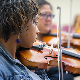 student playing a violin