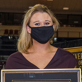 Payton Ramsey holding her framed Swanger Award. 