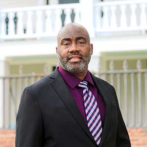 Jackie Whitmore stands in front of a historical building in South Carolina. 