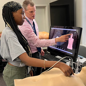 two people using an ultrasound equipment 