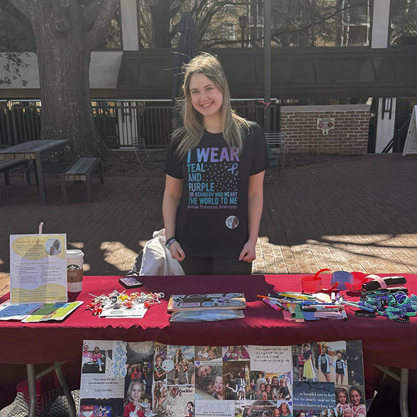 Natalie Jacob-Bell stands at a table on Greene Street