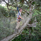 Kneas standing on a forest canopy walk in the Ecuadorian Amazon.